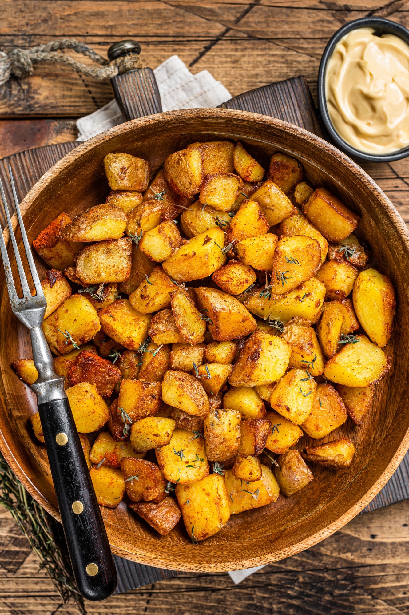 Fried potato - Patatas bravas traditional Spanish potatoes snack tapas. wooden background. Top view