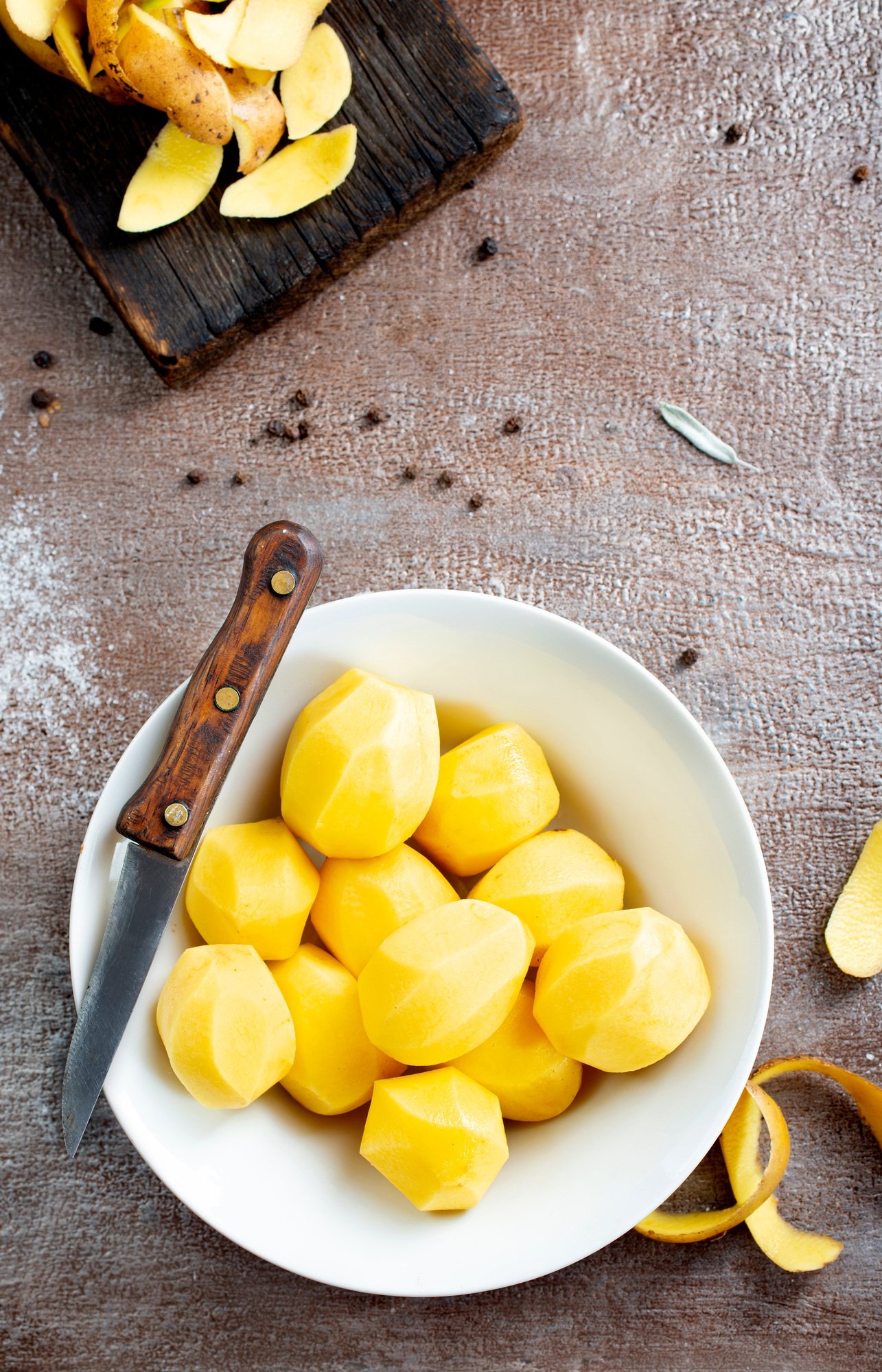 Peeled potatoes for cooking, raw potato on a table